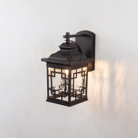 Black metal outdoor wall light on white background with a decorative lattice glass frame overlay for front porch decor.