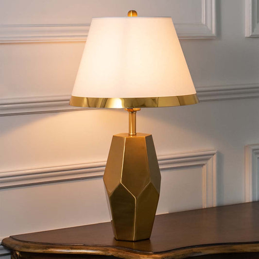 Brown geometric ceramic table lamp with fabric shade creating warm ambient lighting and sophisticated modern decor appeal.