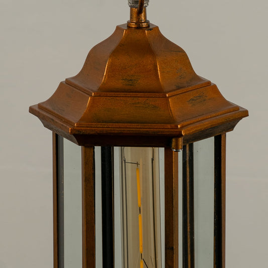 Detailed closeup of copper lantern with light off highlighting metal texture clear glass panels and tidy hexagonal structure perfect for exterior lighting decor.