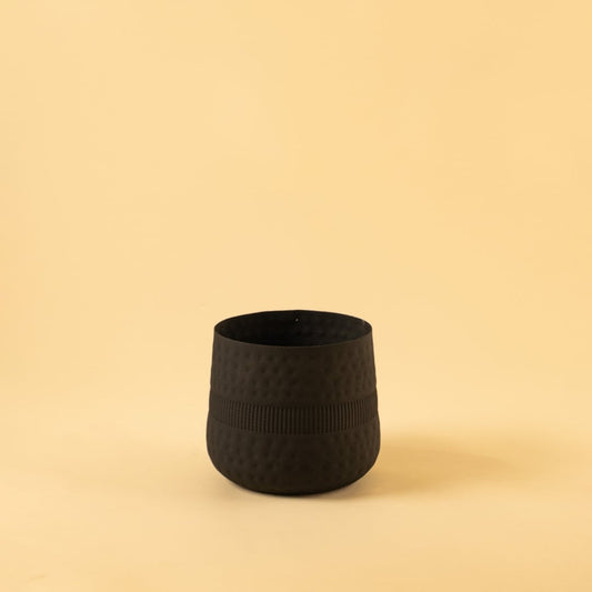Small black textured pot with ribbed design and matte finish displayed on a clean white background for minimal modern decor.