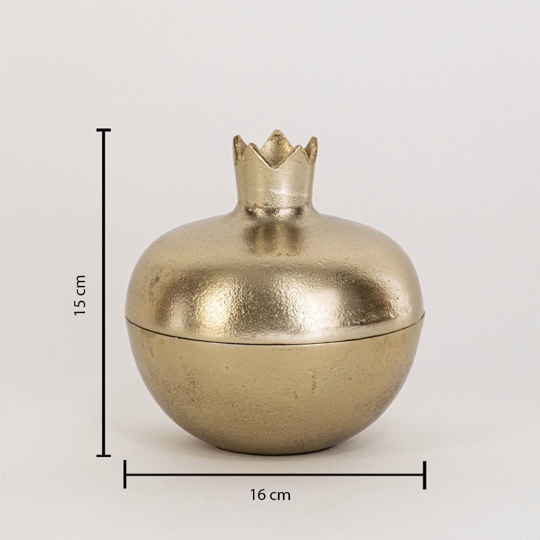 Close view of gold pomegranate storage jar highlighting smooth metallic finish and sculpted crown lid detail.