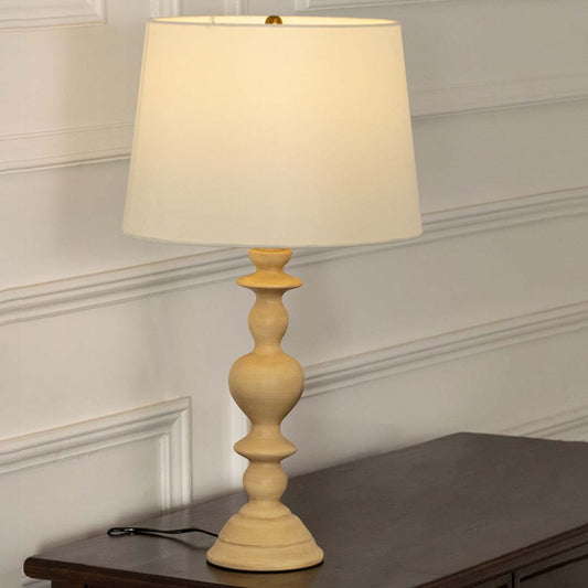 Natural wood table lamp with fabric shade offering warm traditional decor and ambient lighting for stylish interiors.