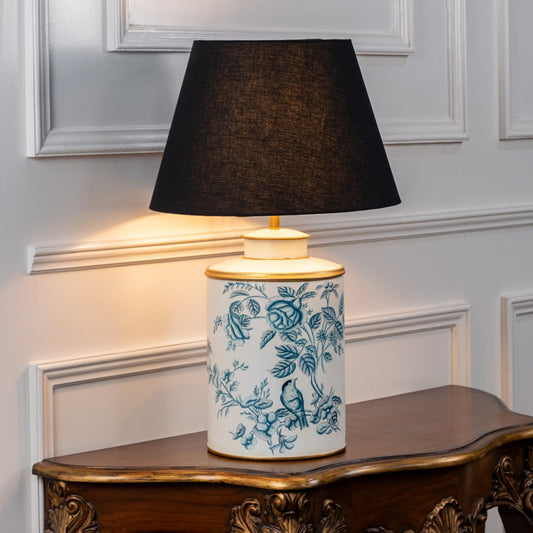 White ceramic table lamp with blue floral pattern and black fabric shade for elegant bedside and living room decor.