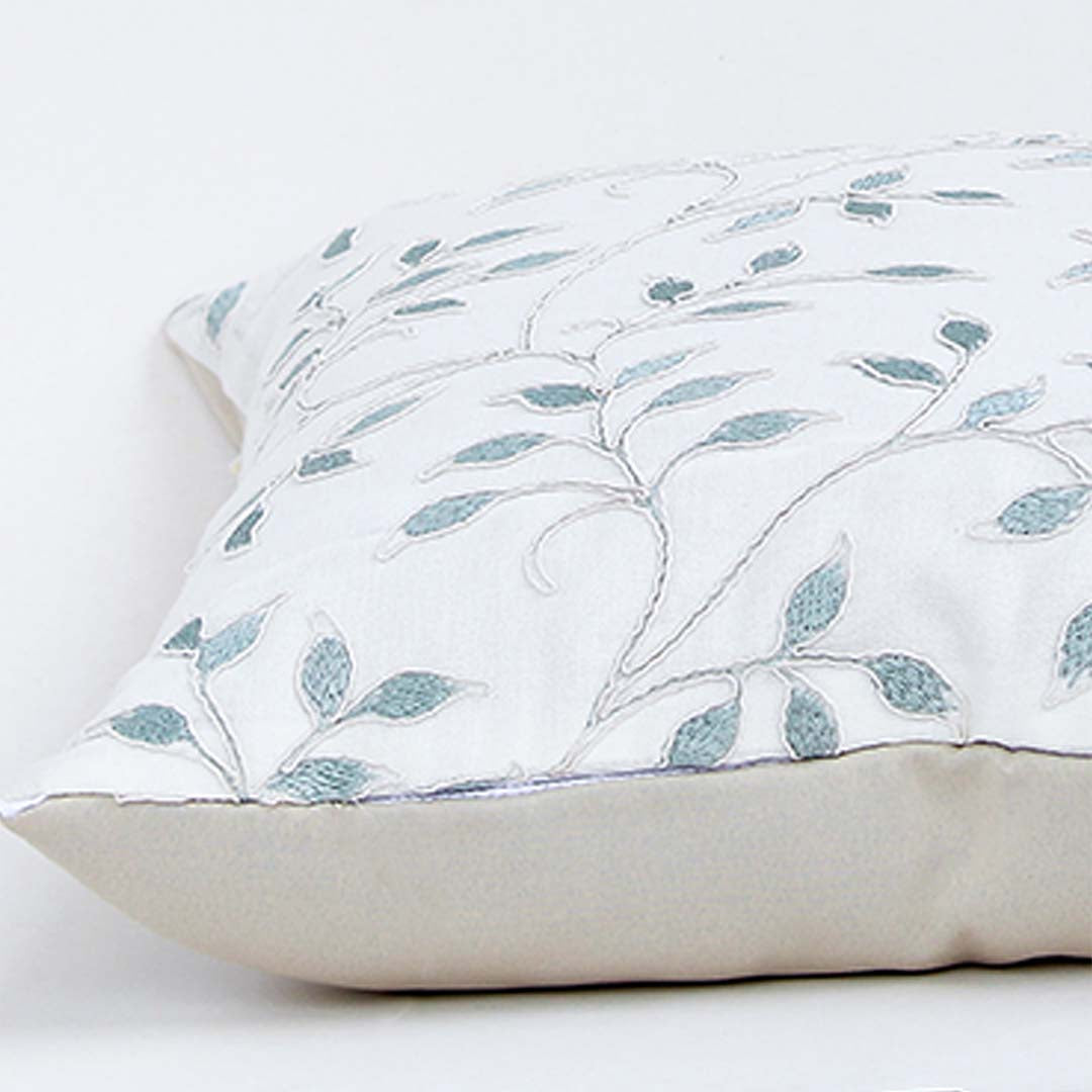 White cotton cushion cover with soft blue botanical leaf print for sofa bedroom and contemporary home decor styling.