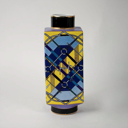 White background image ceramic jar vase with modern geometric blue and yellow artwork and black lid elegant home accent