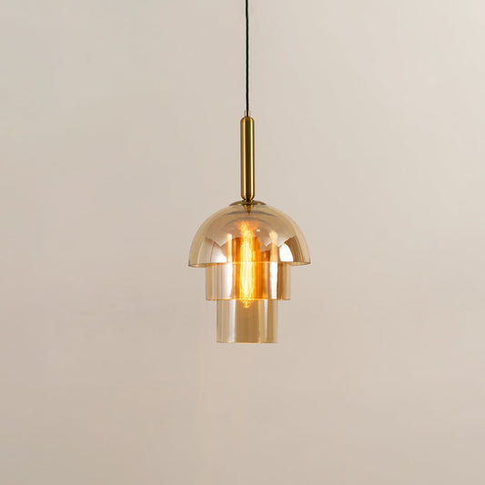A gold glass pendant light displayed with lights on against a white background showcasing its layered dome design and warm glowing illumination.