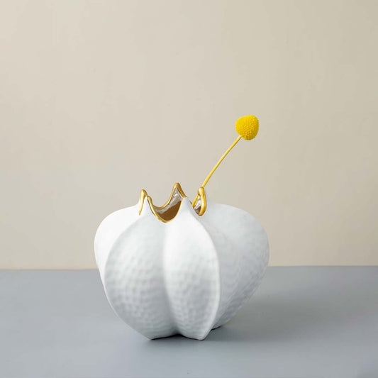 White textured ceramic vase gold accent modern living room decor Main Lifestyle image with single flower.