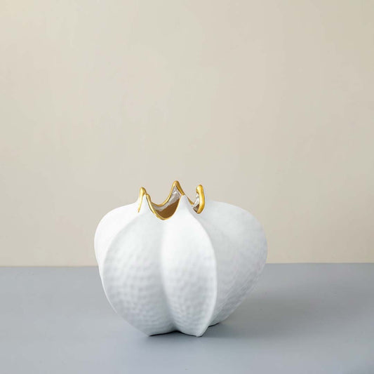 Abstract white ceramic vase with textured body and unique gold accent Scalloped rim Light on White Background.