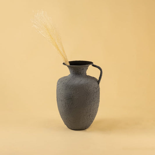 Grey metal jug vase decor styled in a warm modern room adding a bold elegant accent to living room tables and corner spaces.