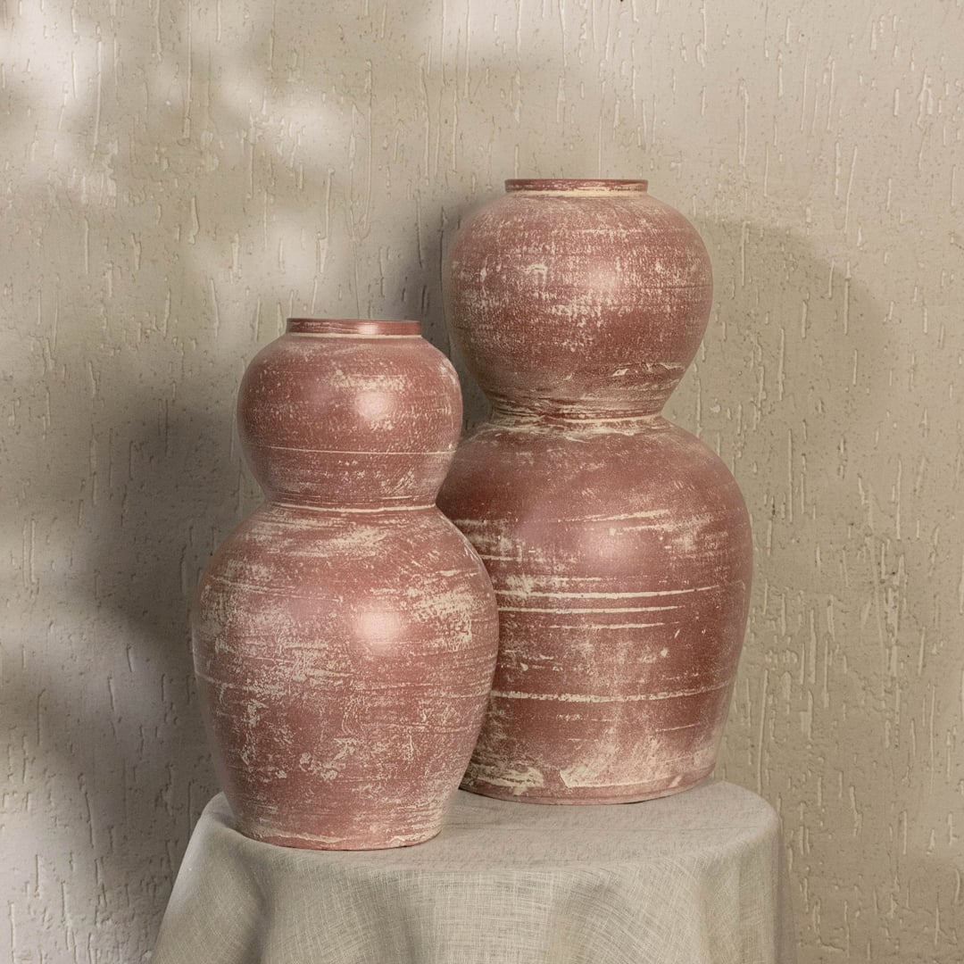 Rustic pink terracotta decorative vase styled in a warm modern room adding artistic earthy charm to living rooms hallways and contemporary interiors.
