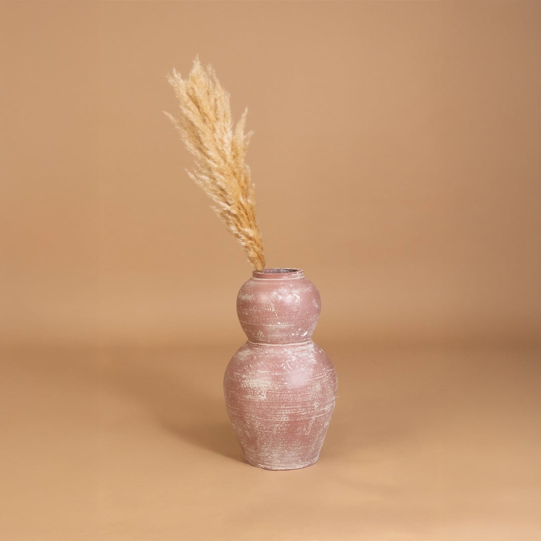 Rustic pink textured decorative vase placed in a curated interior setting enhancing shelves consoles and living areas with warm artistic decor.