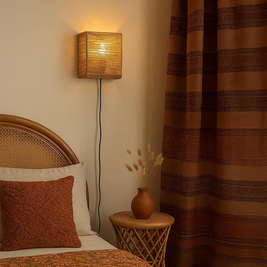 Square wall light with a handwoven natural jute finish adds warmth and earthy texture to contemporary interiors enhancing soft ambient lighting.