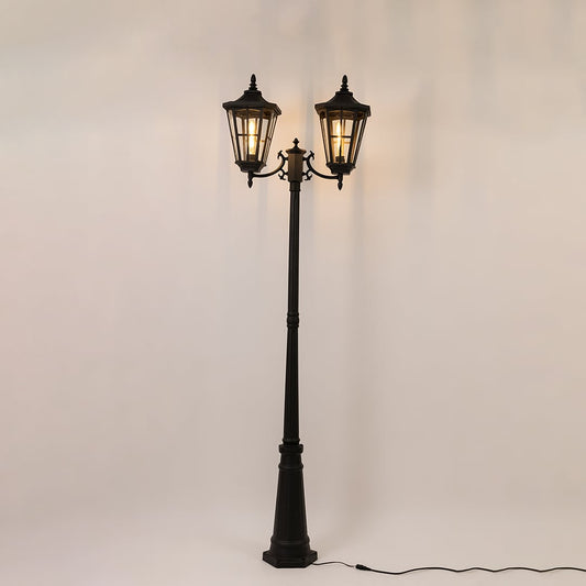 Elegant black outdoor street lamp glowing on a white background ideal for garden patio and driveway lighting.