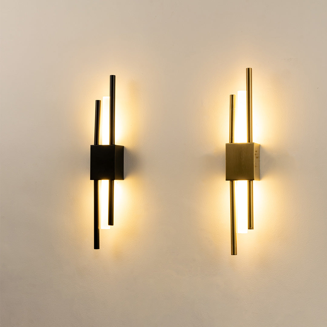 Modern gold metal wall lights glowing on white wall for luxury bedroom hallway and living room decor styling.