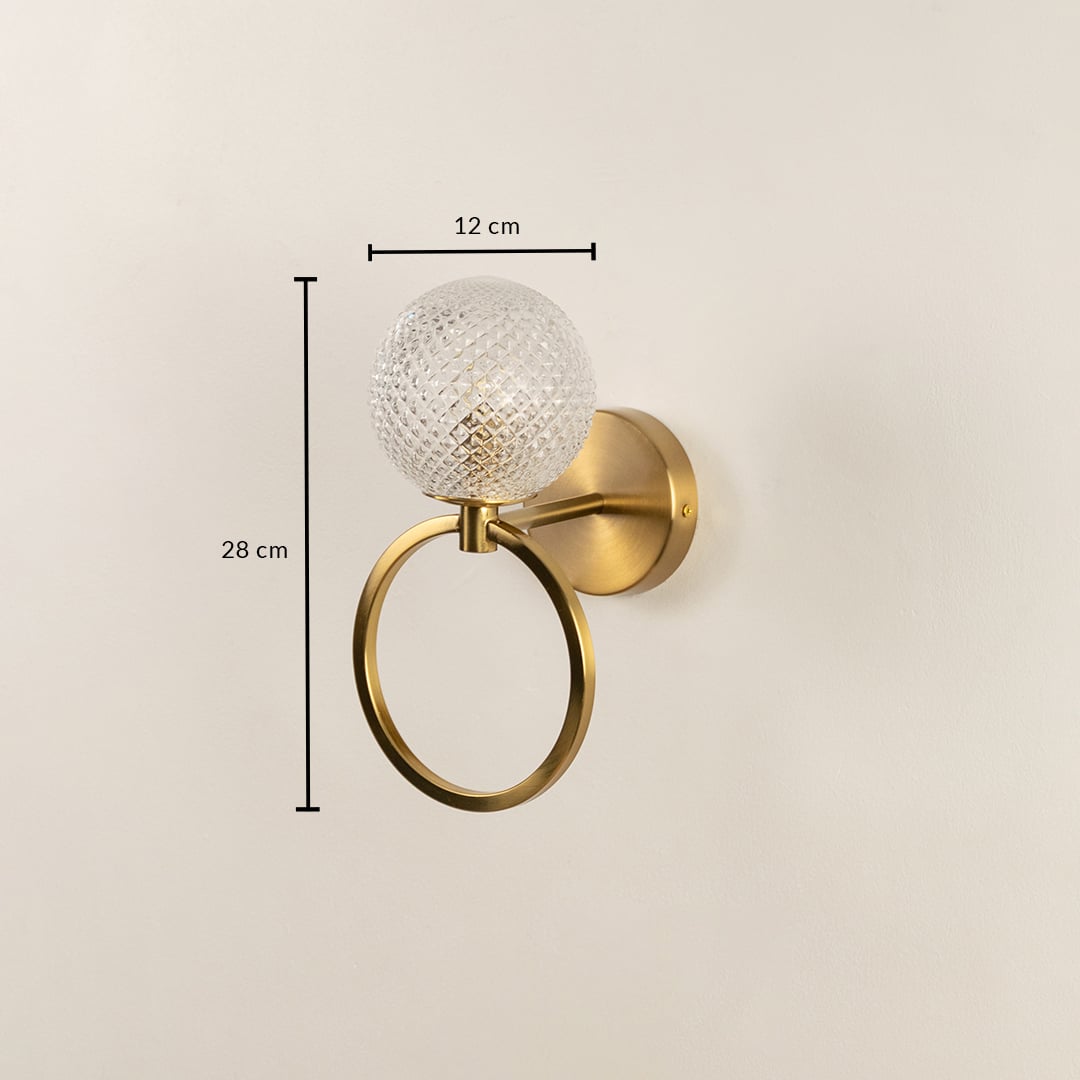 A gold wall light with a circular metal ring and diamond cut glass globe shown with full measurements displaying a height of 28 cm and a width of 12 cm for accurate placement.
