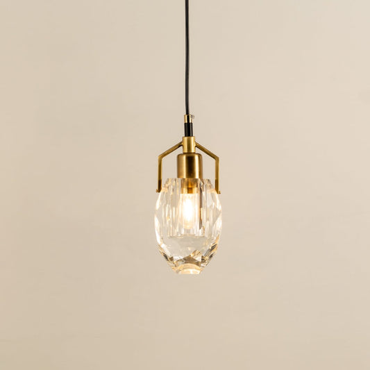 Crystal pendant light with polished metal accents glowing beautifully against a clean white background showcasing refined minimalist interior home decor lighting style.