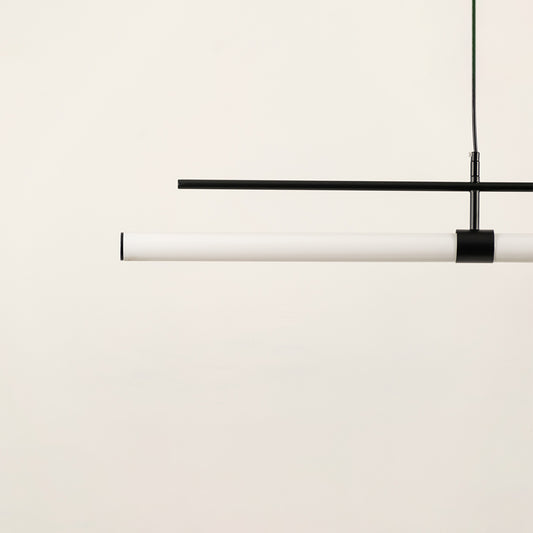 Black and white linear LED pendant light showcasing sleek metal craftsmanship and minimalist contemporary lighting design.