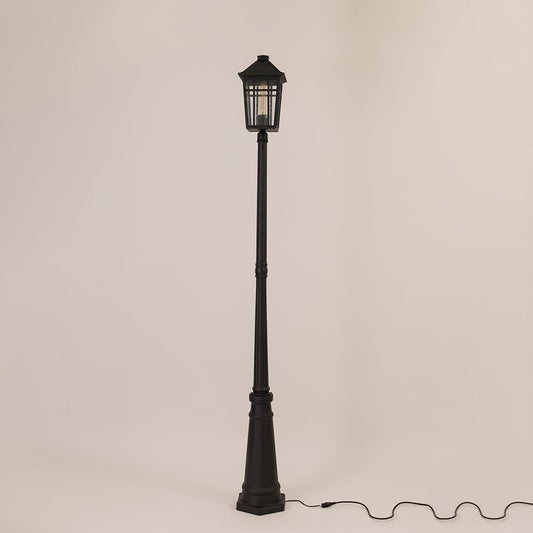 Tall outdoor post lamp in black metal shown unlit on off white background designed for pathway driveway and garden lighting.