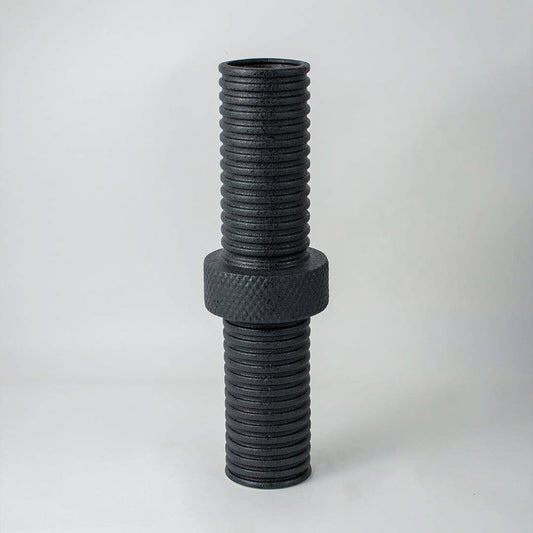 Modern matte black ridged cylindrical vase for minimalist home interiors and stylish contemporary table decor accents.