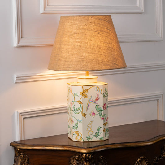 Lost Garden white table lamp on white background with light on offering subtle glow delicate pattern and airy interior decor style.
