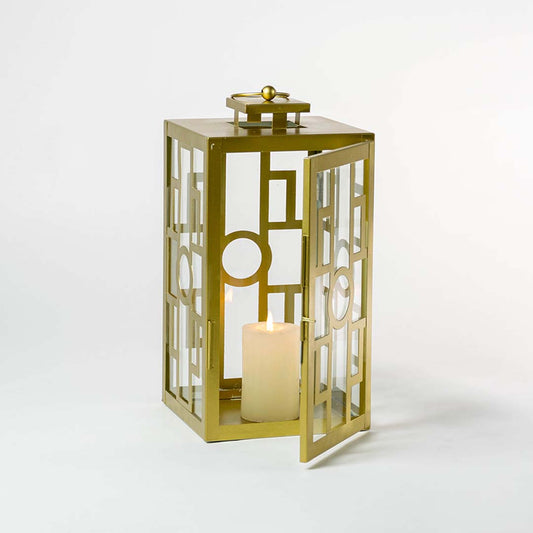 Decorative gold metal lantern with clear glass panels for luxury indoor tabletop decor styling.