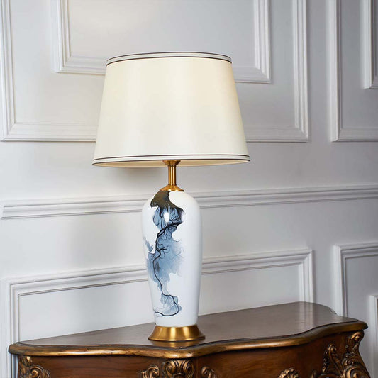 Blue and white floral ceramic table lamp with fabric shade designed for elegant traditional decor and ambient table lighting.