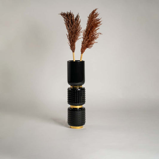 Black and gold textured ceramic vase displayed on a clean white background ideal for modern home decor and elegant interior styling.