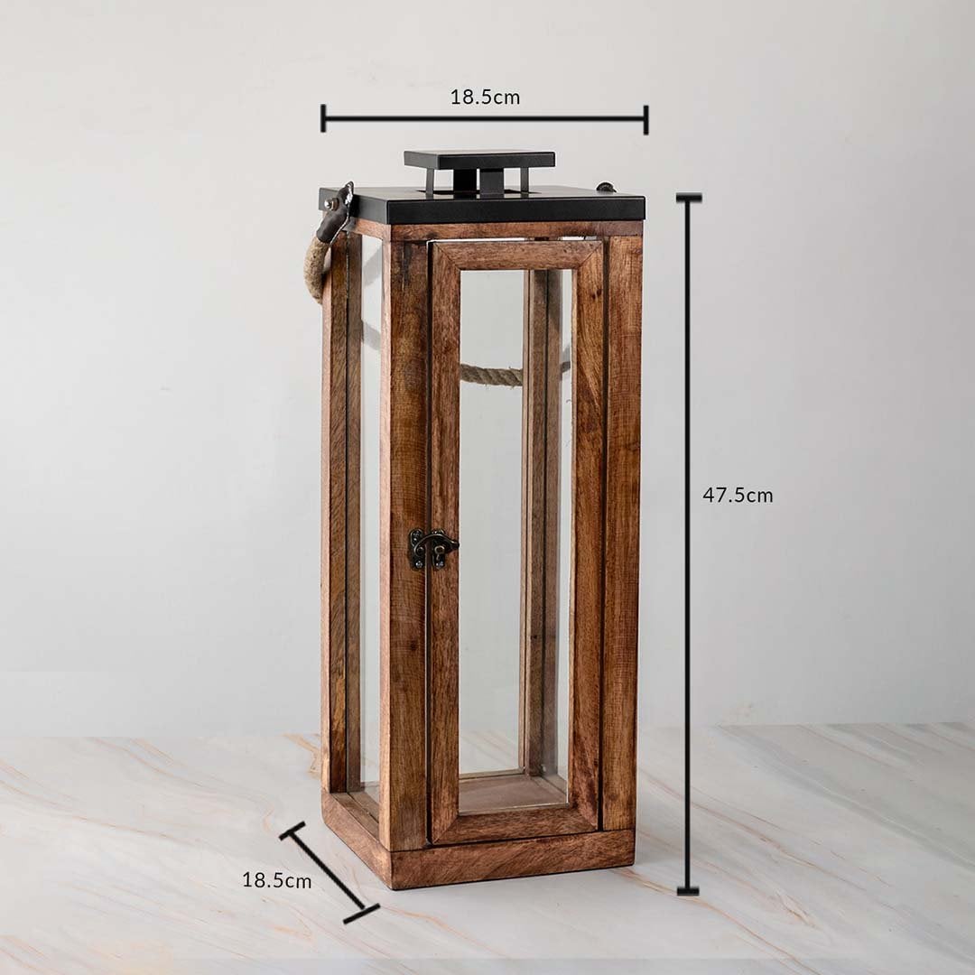 Rustic tall lantern dimensions 47.5cm height and 18.5cm width with glass panels and rope handle.