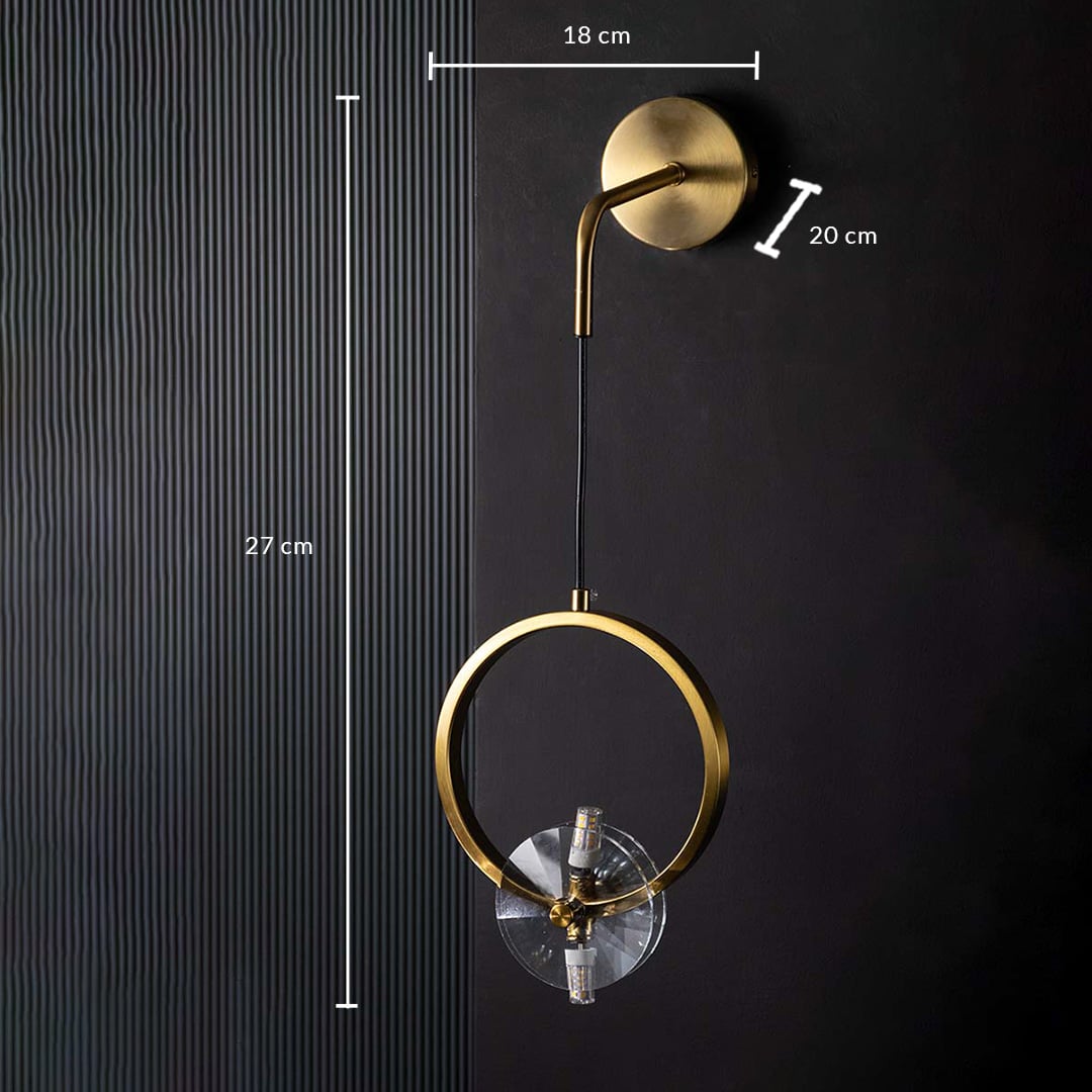 Detailed closeup of gold ring wall light highlighting its circular metal frame and polished glass element for luxury contemporary interior lighting.