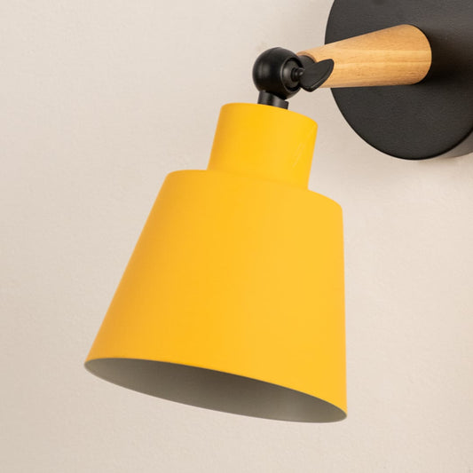 Closeup view of wooden wall sconce with yellow lampshade elegant indoor wall light for bedroom kids room and hallway stylish modern wall lighting.