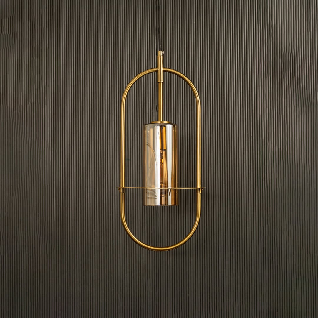 Unlit pendant lamp set against a dark backdrop revealing its modern oval silhouette and subtle metallic sheen.