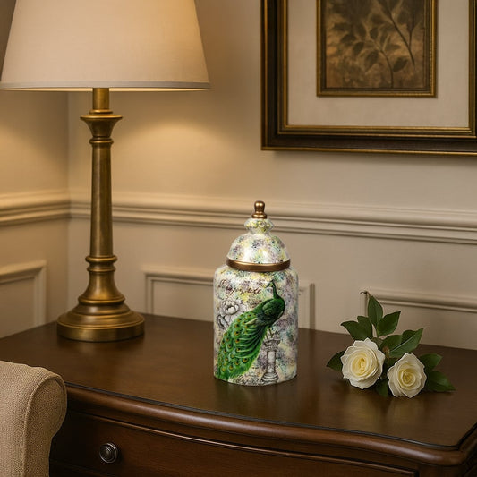 Peacock-themed decorative jar placed on a wooden console beside a gold lamp and white roses adding elegance to interior decor.
