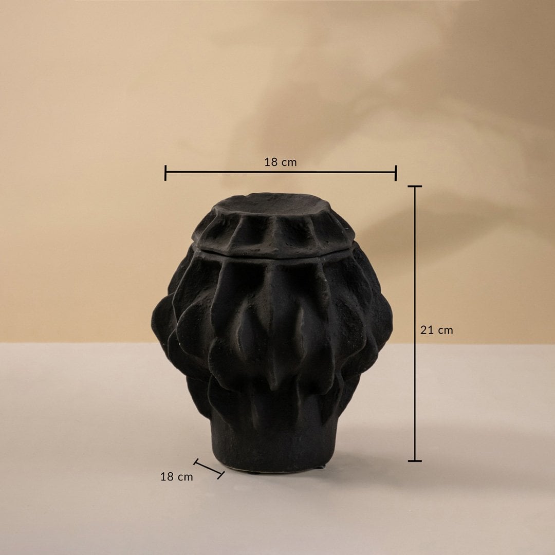 Black handcrafted ceramic vase with sculptural texture displayed on a neutral surface measuring 21 cm in height and 18 cm in width.