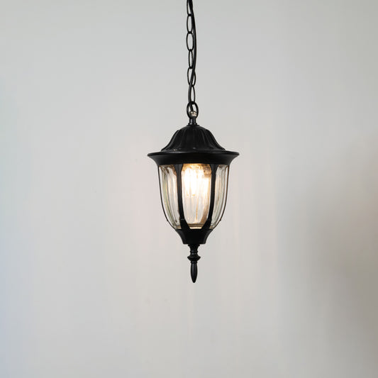 Contemporary black metal hanging lantern light with warm glow for elegant balcony and porch decor.