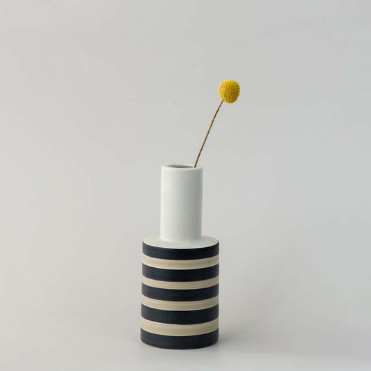White ceramic decorative vase with black stripes and gold detail for tabletop styling and modern home decor.