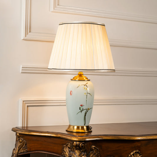 Light blue ceramic table lamp with fabric shade displayed on a carved console table creating refined ambient lighting.