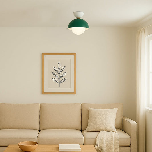 Modern ceiling light in a soft room setting with a green dome shade and a round white globe for gentle ambient lighting.