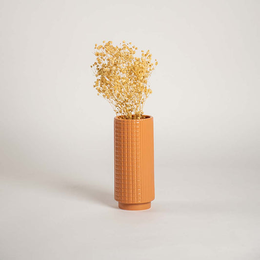 Tall terracotta ceramic textured vase styled in a warm interior space perfect for living rooms hallways and cozy decor accents.