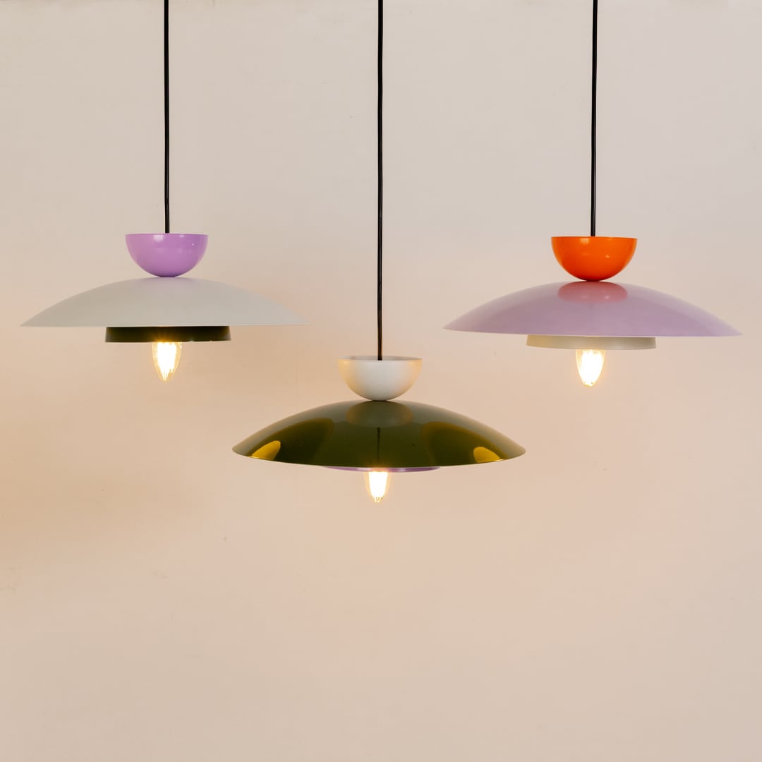 Multicolor metal pendant lights displayed together for modern kitchen dining and living room decor on clean background.