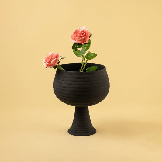 Black metal pedestal bowl decor styled in a warm modern room adding a bold elegant accent to living room tables and shelves.
