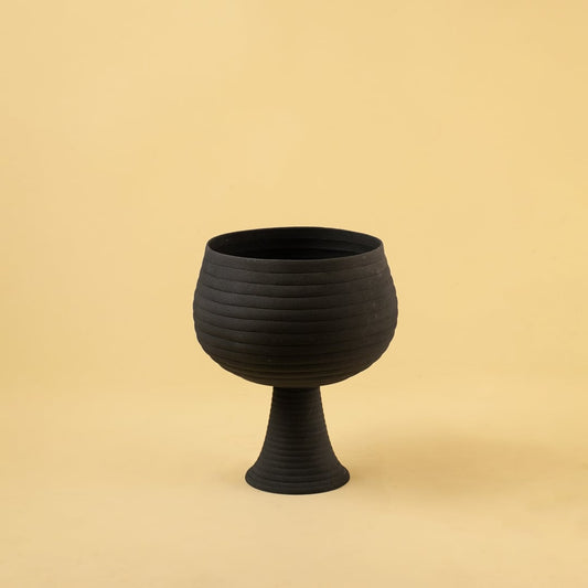 Black metal pedestal bowl decor on a clean white background highlighting its modern textured finish for home styling.