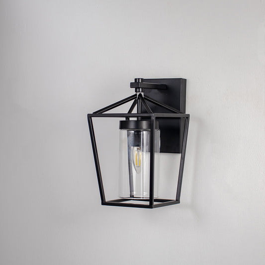 Black metal outdoor wall light on white background with clear glass shade for elegant exterior wall decor.