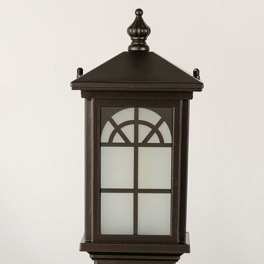 Black outdoor lantern Closeup seeded glass Light On showing the warm ambient glow and decorative pebbled glass panels detail.