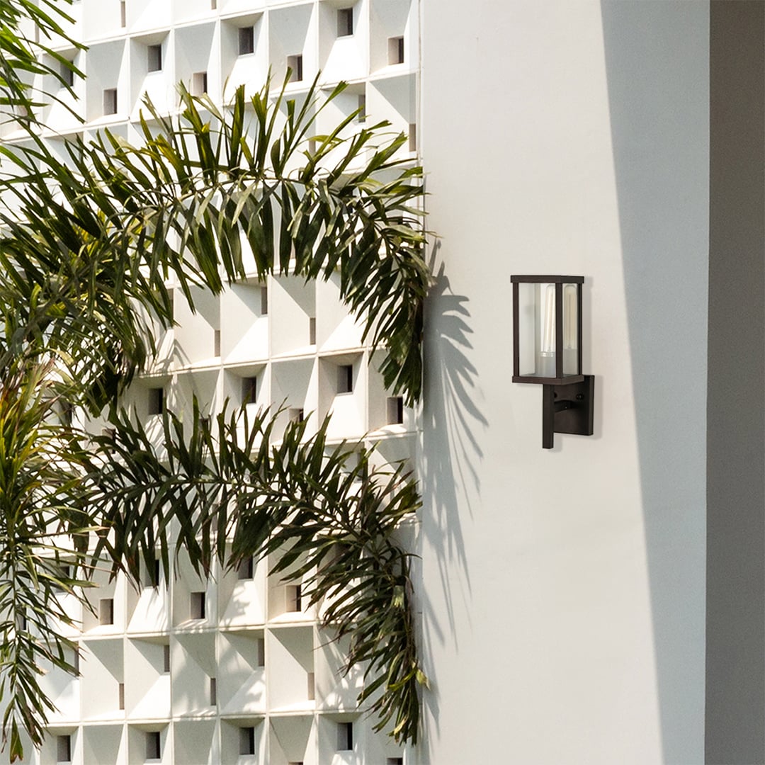 Sleek black outdoor wall light placed on a bright exterior wall enhancing modern outdoor decor with clean lines and soft ambient lighting.