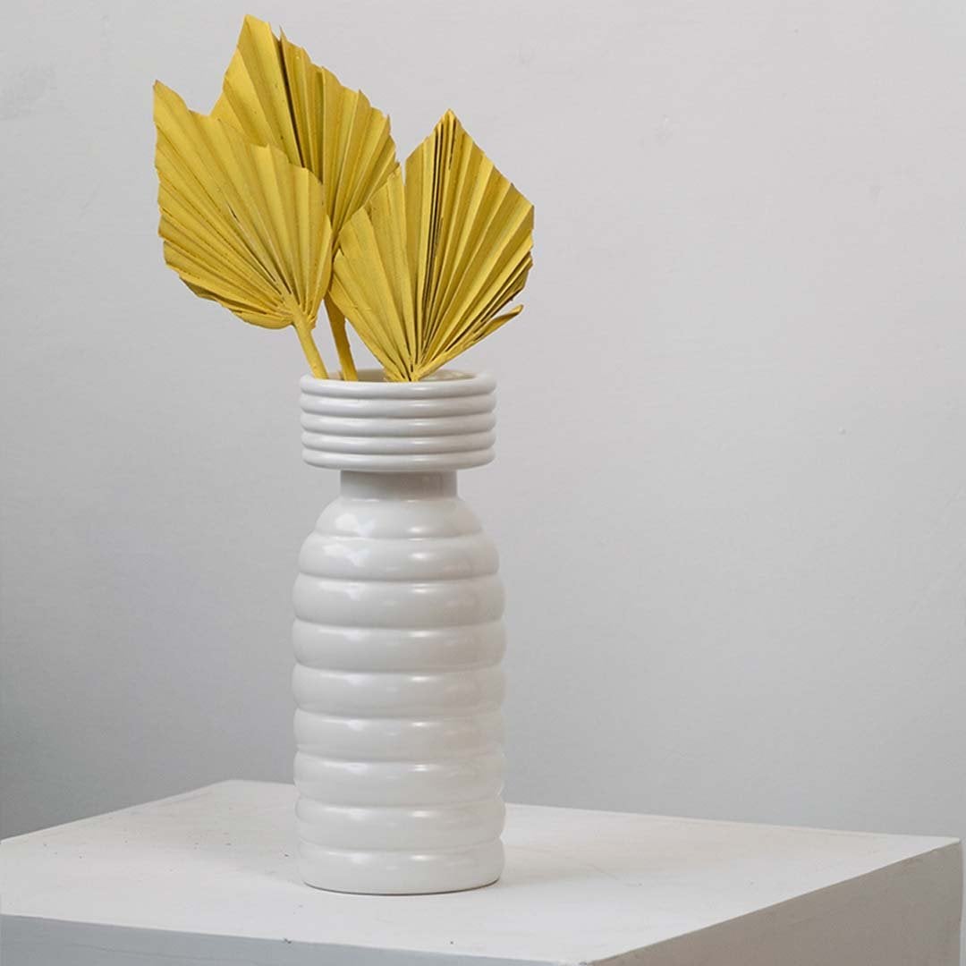 Dried palm leaf yellow decor styled in a modern ceramic vase perfect for boho home decoration and table styling.