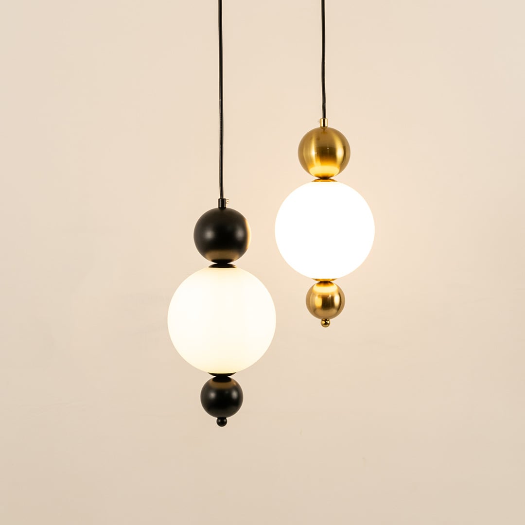 Black and gold metal wall lights illuminated to showcase sophisticated modern wall lighting with refined elegance.