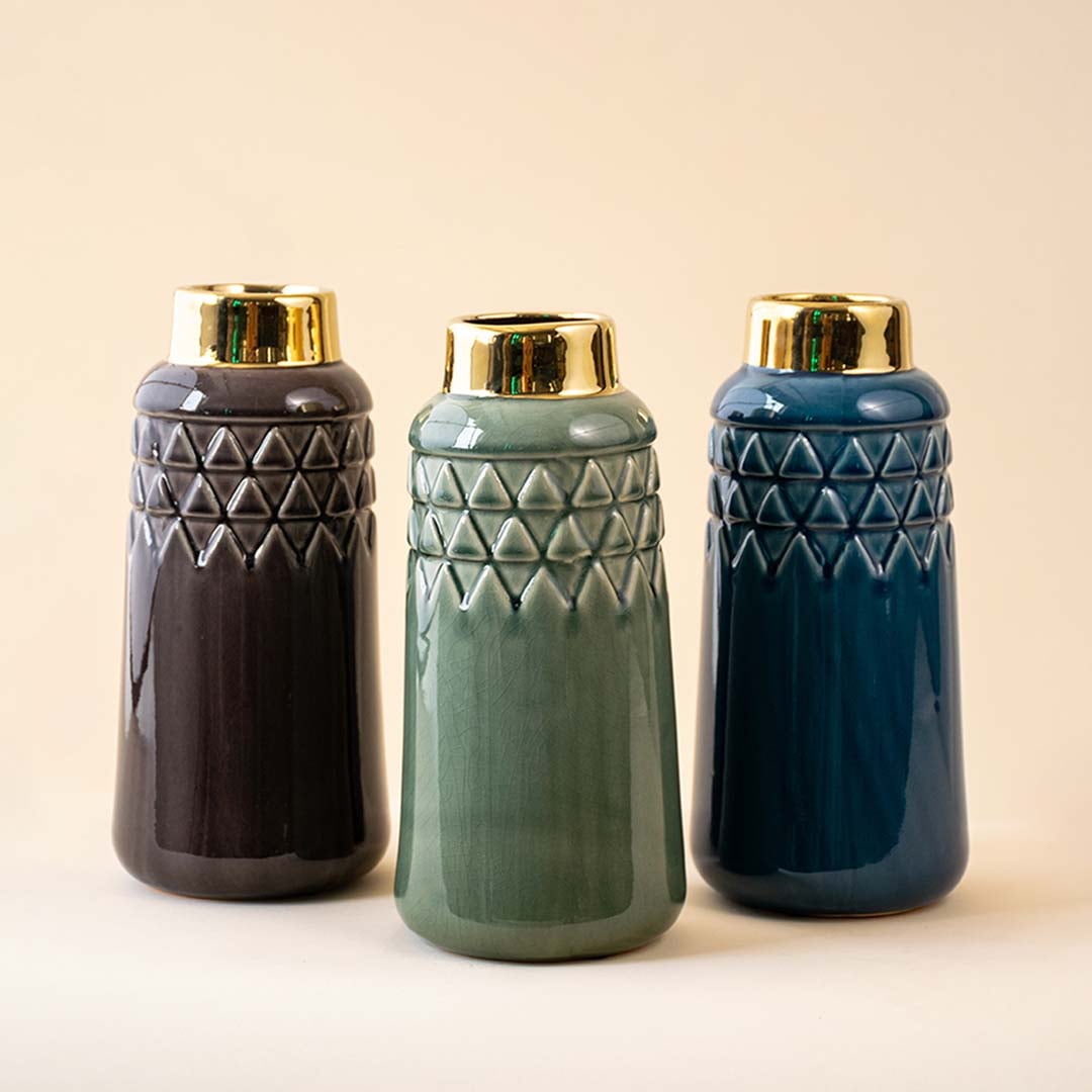 Set of ceramic vases in brown green and blue shades with gold rims displayed together showcasing modern textured designs for coordinated home decor styling.