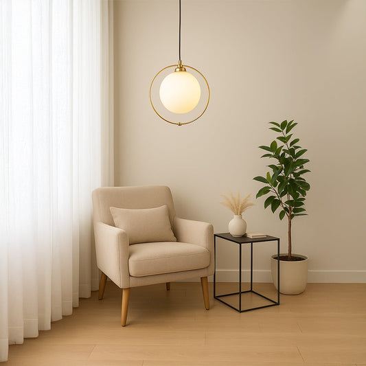 Stylish pendant light with a round frosted globe and gold ring frame shown in a modern lifestyle setting with soft ambient decor.