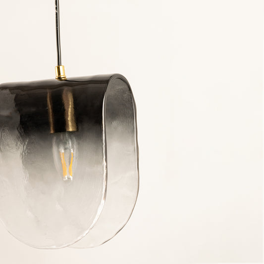 Closeup of smoked glass and black metal hanging wall light for elegant modern decor styling spaces.