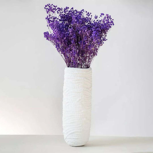 Natural purple dried gypsophila bunch placed on a white background ideal for bright and decorative interior accents.